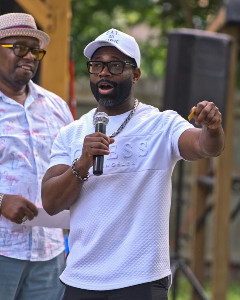 Alonzo Waheed Sr. speaking into a microphone at an outdoor event